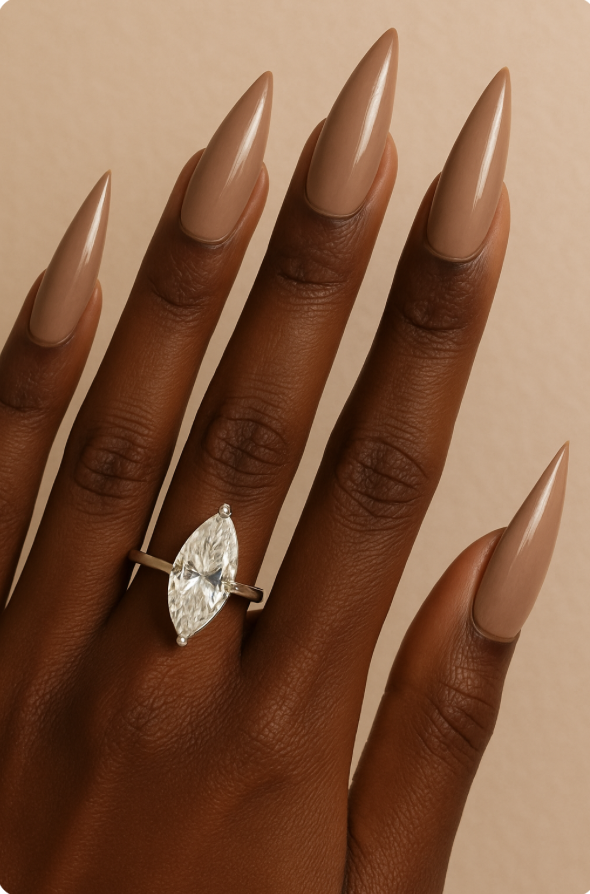 Black woman's hand with marquis engagement ring and stiletto shaped nails