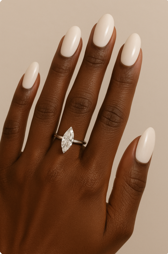 Black woman's hand with marquis engagement ring and oval shaped nails